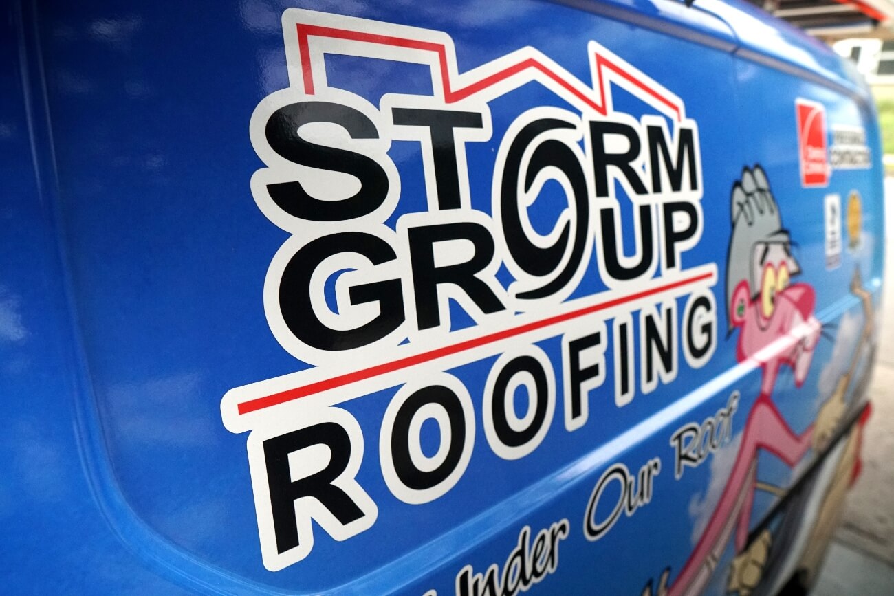 Close view of the Storm Group Roofing logo on their van